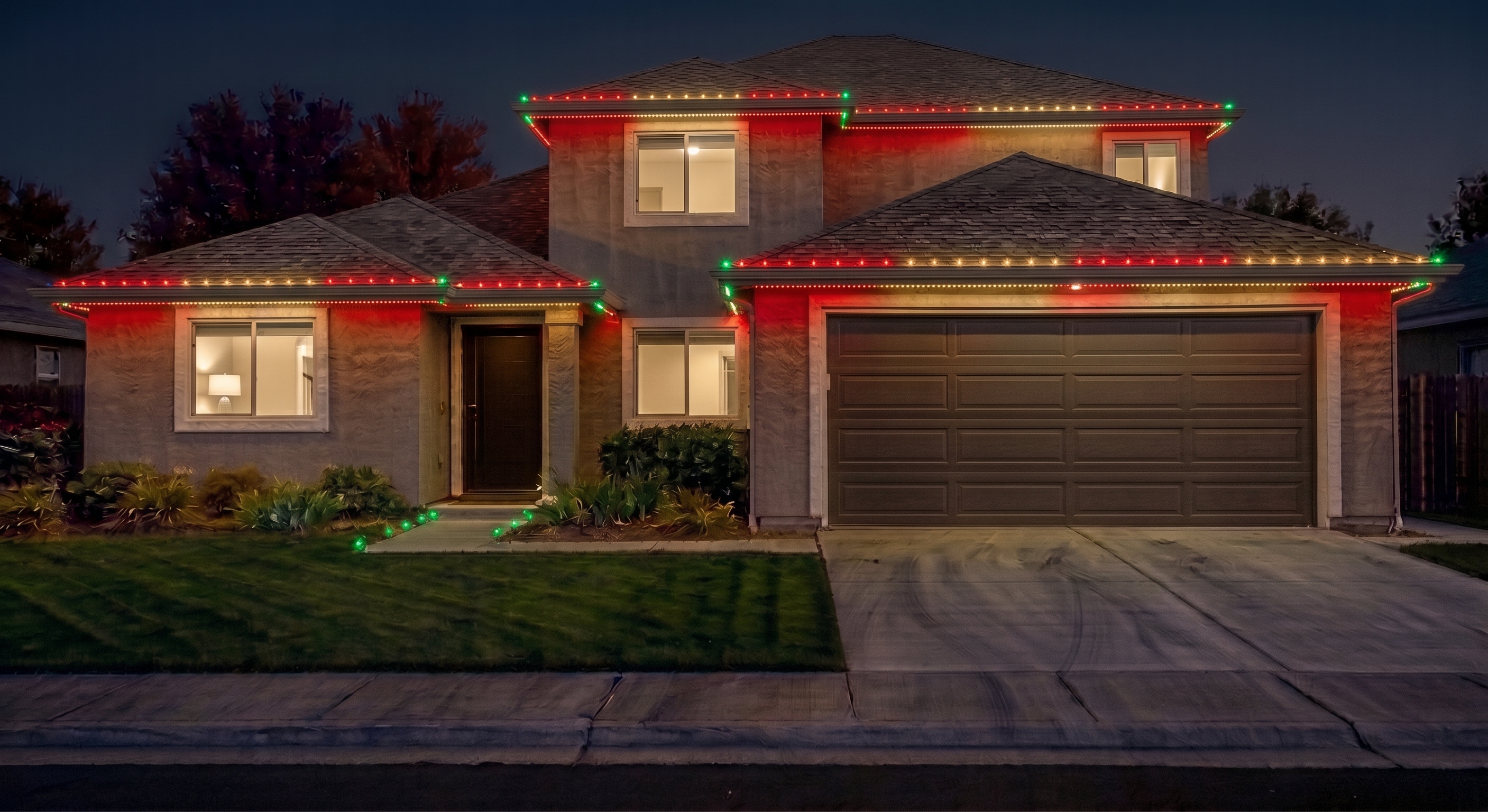 Home exterior with red and green holiday accent lighting